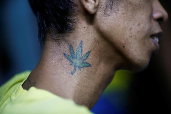 A tattoo is seen on the neck of an inmate in an underground cell 