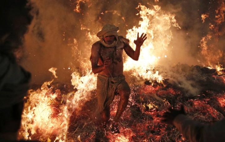 Hindu priest jumps out of a fire
