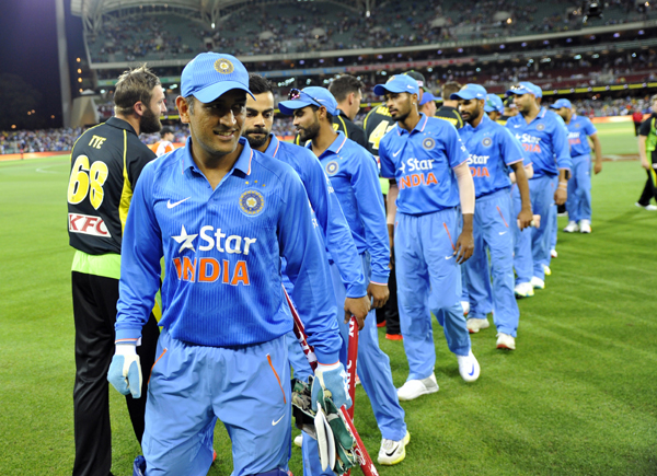 Dhoni leads the team out
