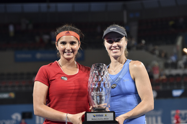 Sania Mirza and Martina Hingis holding the Brisbane International title