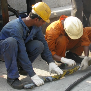 technicians working on the undersea telecommunications cable before it connects to shore