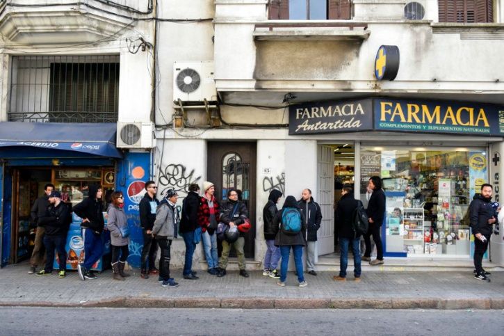 Marijuana aficionados lined up at pharmacies across Uruguay on Wednesday to become the first to legally buy pot from pharmacies as a law regulating its sale took full effect