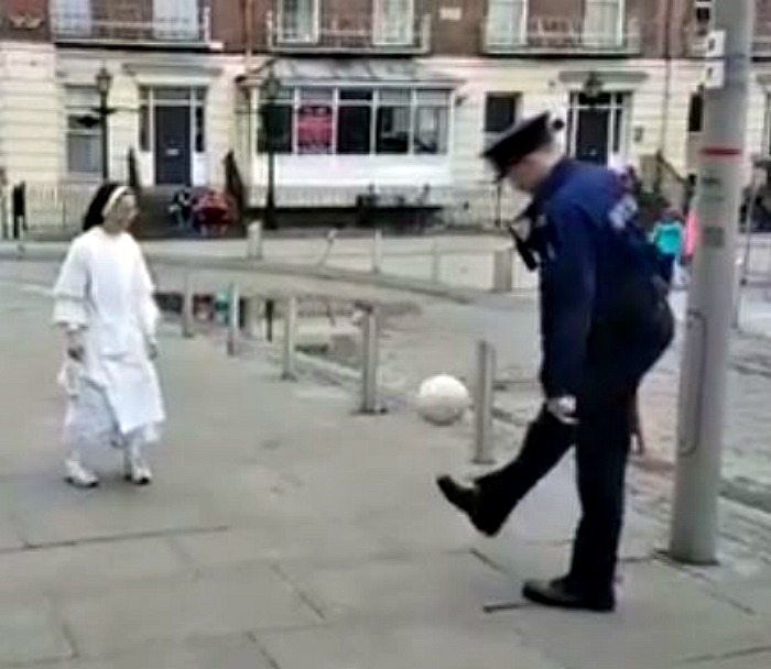 Nun plays football with policeman