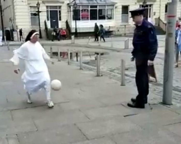 nun plays football with policeman