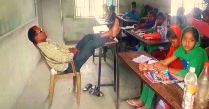 bihar teacher keeps legs on desk, dozes off during class while students wait to study