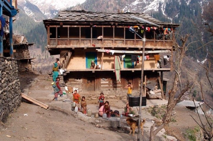 Residents of Malana doing daily chores like filling water in pitchers on a regular day.