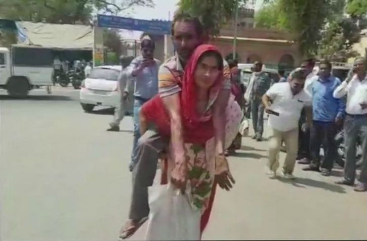 Woman Carries Husband On Her Back