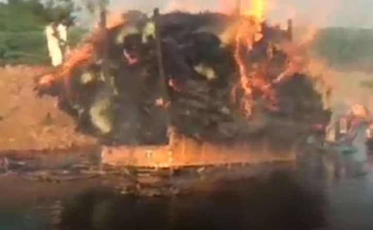 man drives burning tractor into lake to save more than 100 homes