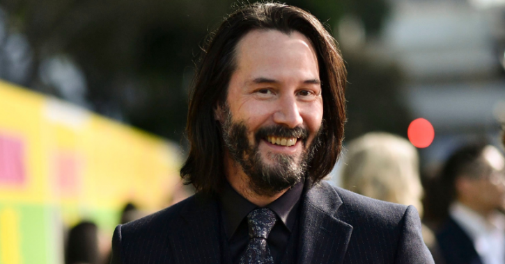 A picture of Keanu Reeves smiling.