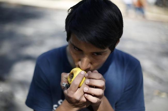 Man smokes marijuana in an apple pipe during the 4th Marijuana Festival outside the Senate building in Mexico City