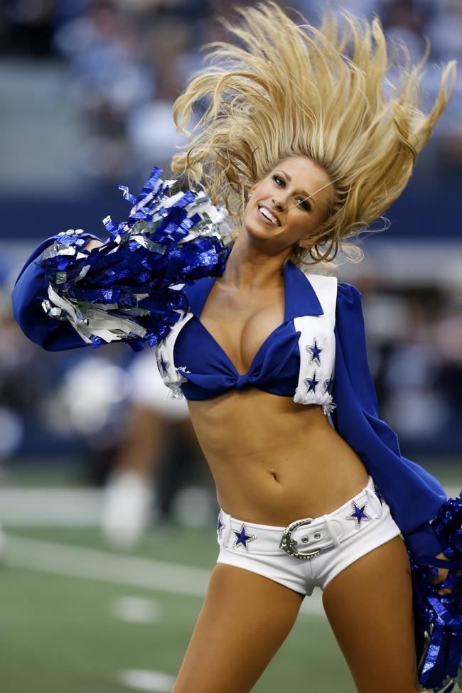 A member of the Dallas Cowboys cheerleaders performs during an NFL football...