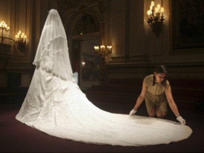 Expensive Bridal dresses made of lace, bridal satin and feather accessory.