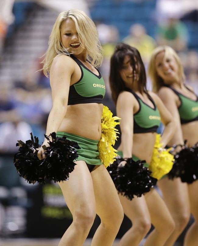 Oregon cheerleaders perform during a semifinal Pac-12 tournament NCAA colle...