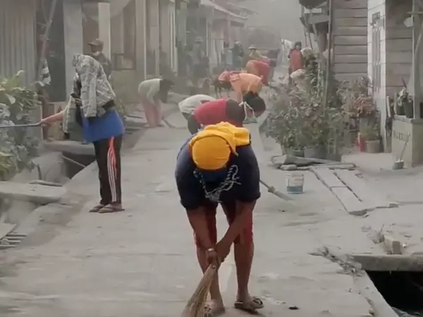 Women sweep a pathway covered in ash after the eruption of Mount Sinabung volcano in Karo, North Sumatra Province, Indonesia.