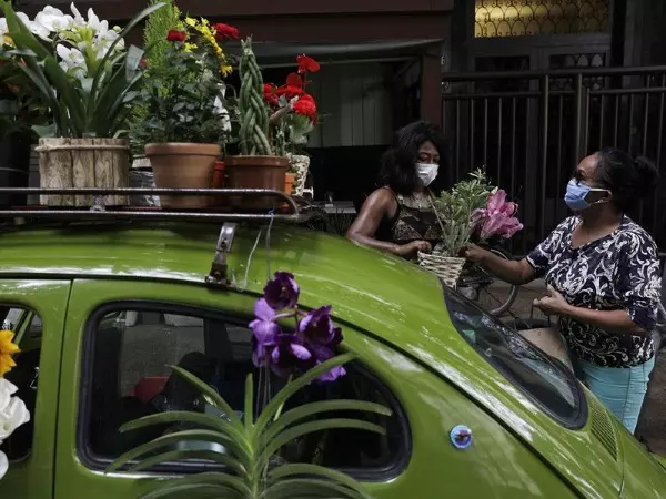 Woman Sells Flowers In VW Beetle