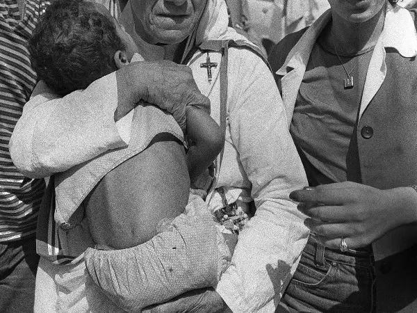 Mother Teresa who awarded a Peace Nobel Prize hugs a child in West Beirut 14 August 1982. 