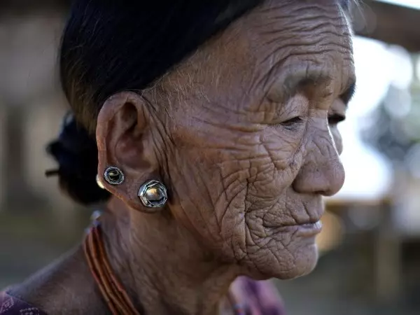 Nguntoi Konyak, 85, sits outside her home in Oting village, in the northeastern Indian state of Nagaland, Thursday, Dec. 16, 2021. "They killed innocent villagers. All the young boys of this village have been killed," Nguntoi said. High up in the hills al
