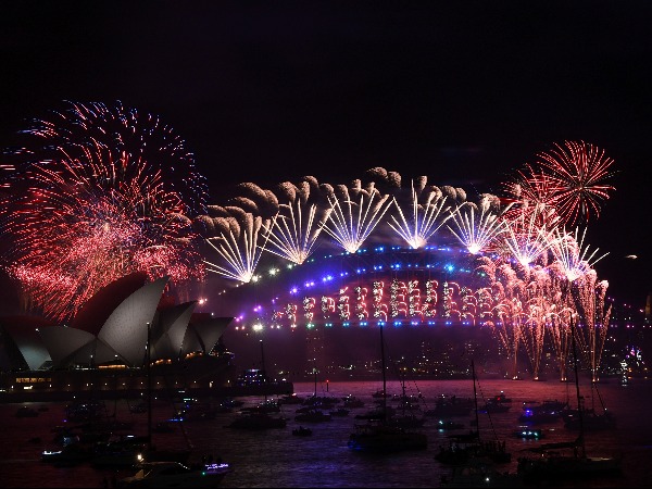 Fireworks explode over the Sydney Opera House and Harbour Bridge during New Year