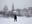 A couple hugs on a frozen pond near the Novodevichy Convent during snowfall in Moscow, Russia.