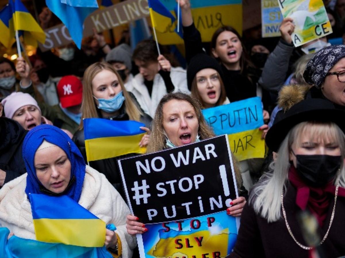 Demonstrators hold banners as they shout slogans during a protest outside the Russian consulate in Istanbul, Turkey.