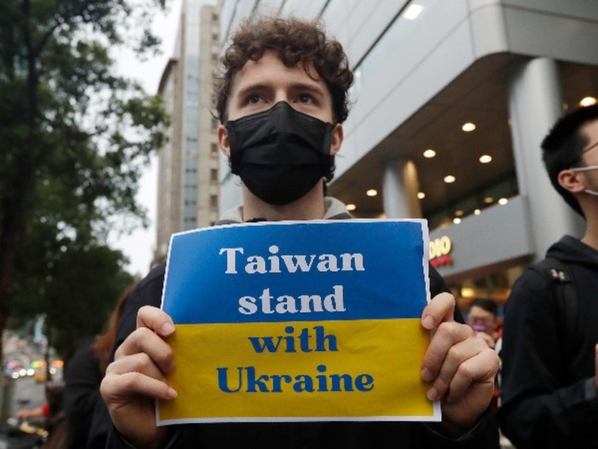 A man holds a poster as he joins a group of Ukrainian people in Taiwan and supporters to protest against the invasion of Russia in solidarity with the Ukrainian people in front of the Representative Office of the Moscow-Taipei Coordination Commission in T