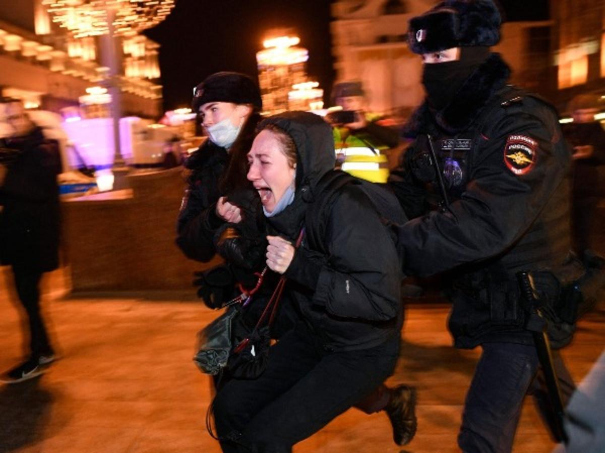 Police officers detain a demonstrator during a protest against Russia's invasion of Ukraine in Moscow 