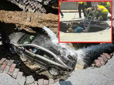 Ohio woman rescued after car falls into massive sinkhole