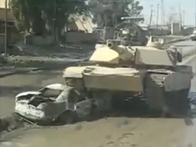 Tank Rolls Over a Bomb