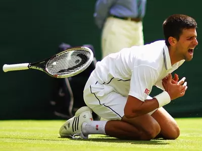 Novak Djokovic takes a concerning tumble during his match against Gille Simon in the third round match at the Wimbledon 2014.